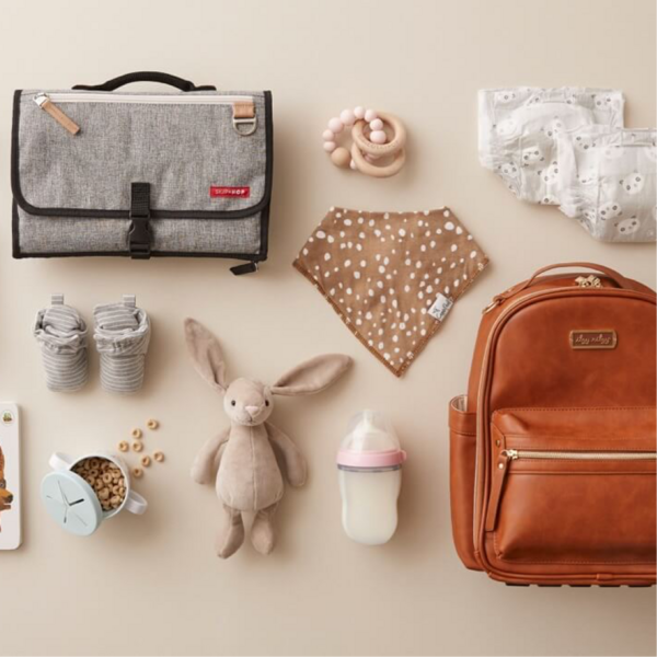 Baby travel gear laid out on a table.