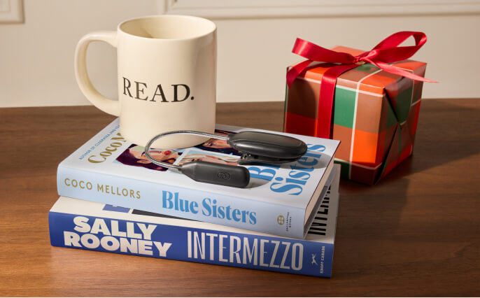 Two books with a mug on top.