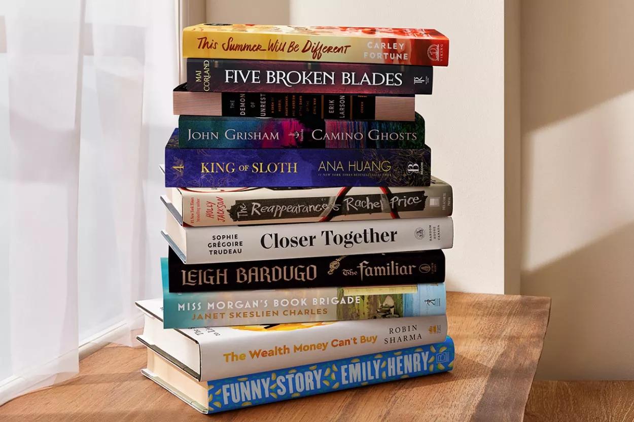 Stack of books featuring This Summer Will Be Different & Five Broken Blades