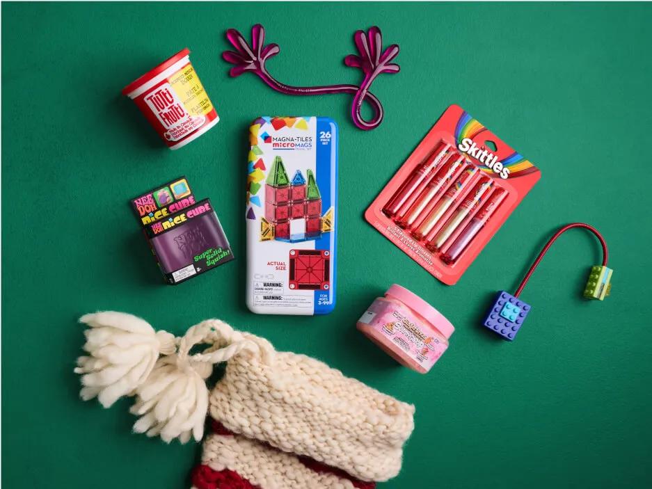 An assortment of stocking stuffers spilling out of a stocking.