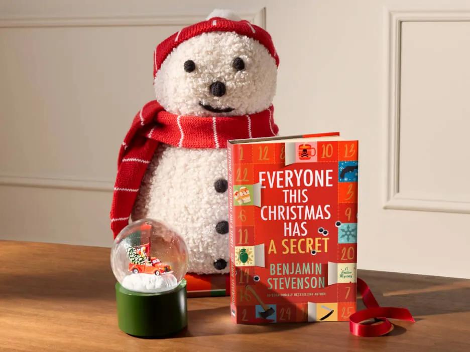 Gifts for the Christmas lover, including a snow globe and snowman shaped pillow.