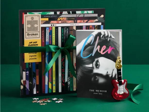 Gifts for the music lover, including the book Cher: The Memoir, Part One and a vinyl record-shaped jigsaw puzzle.