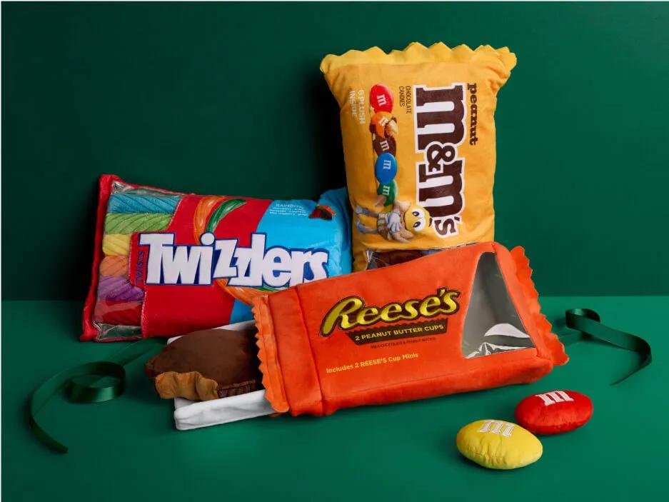 Candy brand pillows including Twizzlers, M&Ms, and Reese's.